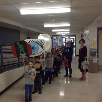 Students in hallway with signs 